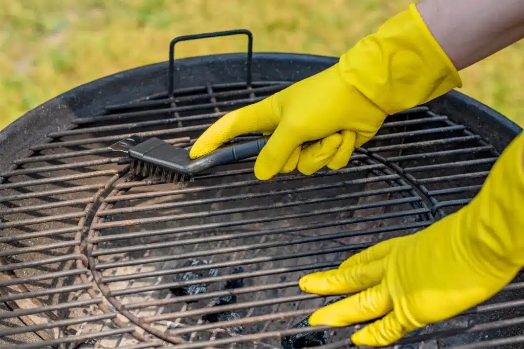 Technician deep-cleaning a built‑in barbecue grill with eco‑friendly products in Orange County